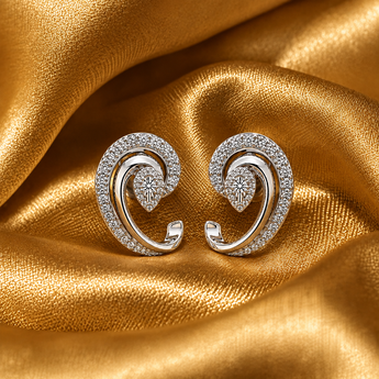 Silver pavé swirl stud earrings with pear-cut centre on gold satin