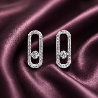 Silver pavé open link stud earrings with a floating centre stone on plum satin