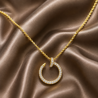 Gold-plated pavé nail circle pendant necklace on bronze satin