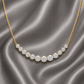 Gold-plated graduated riviera smile necklace with round stones on grey satin