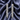 Long silver pavé leaf vine drop earrings on navy satin