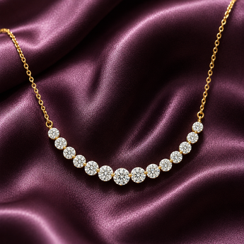 Gold-plated graduated riviera curve necklace on plum satin