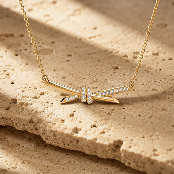 Gold-plated silver bow pendant with stone-set centre and chain
