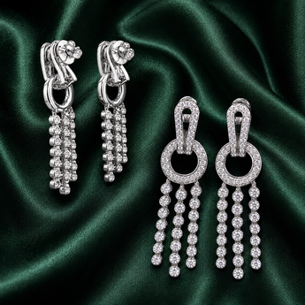 Silver pavé tassel drop earrings shown from two angles on green satin