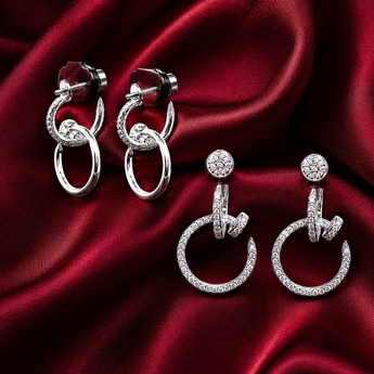 Silver pavé interlocking hoop and nail-motif earrings on red satin