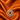 Gold-plated marquise pinwheel medallion pendant necklace on orange satin