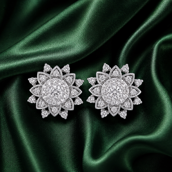 Silver pavé floral cluster stud earrings on green satin