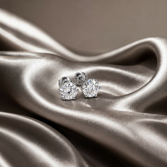 ATJ - 115 silver solitaire round stud earrings with silver screw backs on champagne satin