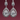 Pear Cut Diamond Halo Drop Earrings – Close-up Macro, Maroon Background